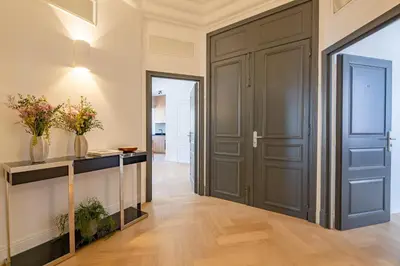 a hallway with a door and a table with flowers at La Guitare 24 - Nice studio in center of Cannes, just behind Grand Hotel in Cannes