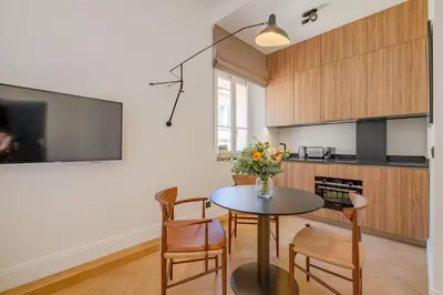 a kitchen and dining room with a table and chairs at La Guitare 24 - Nice studio in center of Cannes, just behind Grand Hotel in Cannes