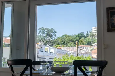 a table with wine glasses and a view from a window at Cozy 2-Br Apartment 6 Minutes from the Beach in Cannes