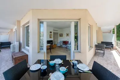 a dining room with a table and chairs at Cozy 2-Br Apartment 6 Minutes from the Beach in Cannes