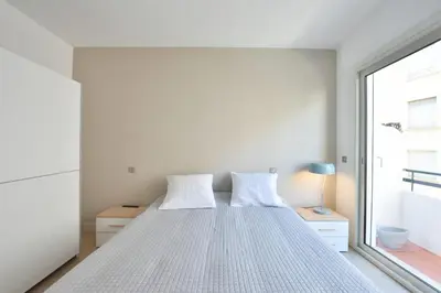 a bedroom with a bed and a window at 3-Room Apartment in the Heart of Cannes in Cannes