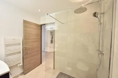 a bathroom with a shower with a glass door at 3-Room Apartment in the Heart of Cannes in Cannes