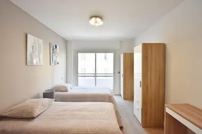 a bedroom with two beds and a window at 3-Room Apartment in the Heart of Cannes in Cannes