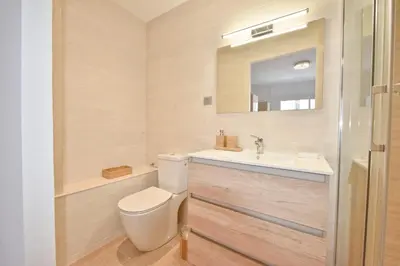 a bathroom with a toilet and a sink and a mirror at 3-Room Apartment in the Heart of Cannes in Cannes