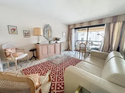 a living room with a couch and a table at Luxury 1 bedroom Jardins Croisette 5 mins Croisette 265 in Cannes