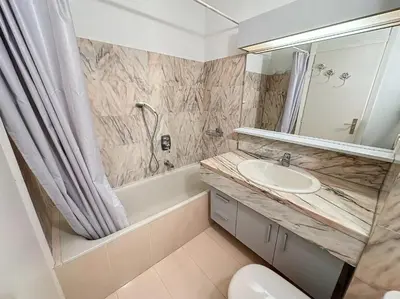 a bathroom with a sink and a tub and a mirror at Luxury 1 bedroom Jardins Croisette 5 mins Croisette 265 in Cannes