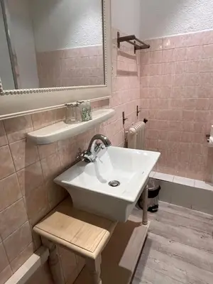 a bathroom with a sink and a mirror at Azurene Royal Hotel in Cannes