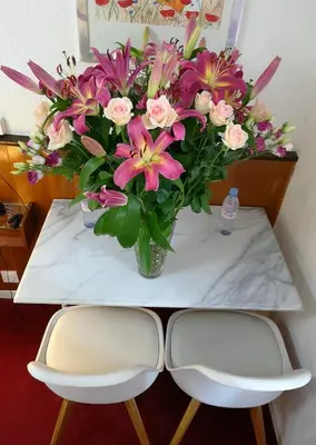 a vase of flowers sitting on top of a table at Azurene Royal Hotel in Cannes