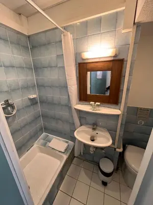 a small bathroom with a sink and a toilet at Azurene Royal Hotel in Cannes