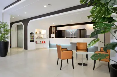a living room with a table and chairs at Résidence Residéal Premium Cannes in Cannes