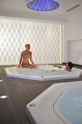 two people sitting in a bath tub in a bathroom at Résidence Residéal Premium Cannes in Cannes