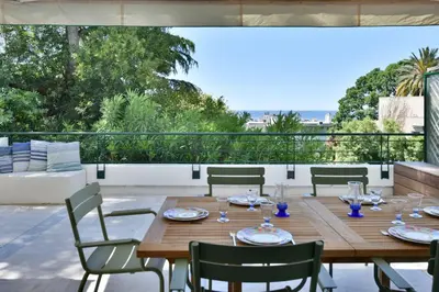 a living room with a couch and a table at Stunning 3-Br Apartment with Large Terrace and Pool in Cannes