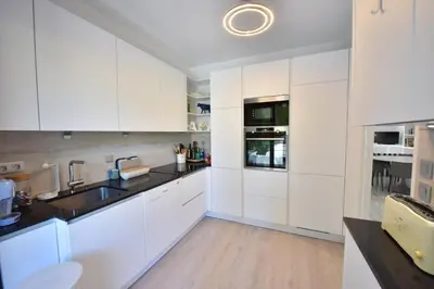 a patio with a table and chairs and trees at Stunning 3-Br Apartment with Large Terrace and Pool in Cannes