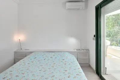 a bedroom with a bed and a table and chairs at Stunning 3-Br Apartment with Large Terrace and Pool in Cannes