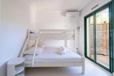 a living room with a table and chairs and a lamp at Stunning 3-Br Apartment with Large Terrace and Pool in Cannes
