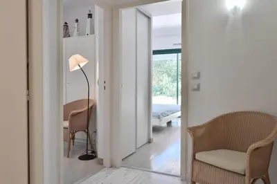 a bedroom with a bed and a chair and a lamp at Stunning 3-Br Apartment with Large Terrace and Pool in Cannes