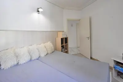 a bedroom with a blue bed with two pillows at Stunning 3-Br Apartment with Large Terrace and Pool in Cannes