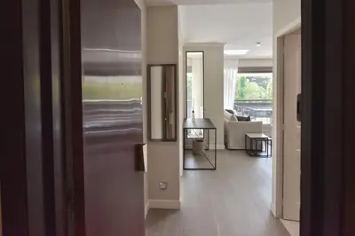 a hallway with a living room with a couch and a table at CANNES - 2-BR flat 15-min walk to the beaches in Cannes