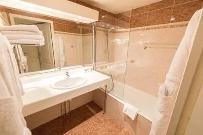 a bathroom with a sink and a shower at Cannes Croisette Prestige Apart'hotel in Cannes