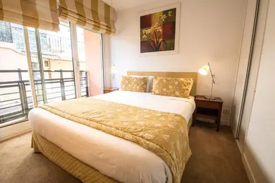 a bedroom with a large bed and a window at Cannes Croisette Prestige Apart'hotel in Cannes
