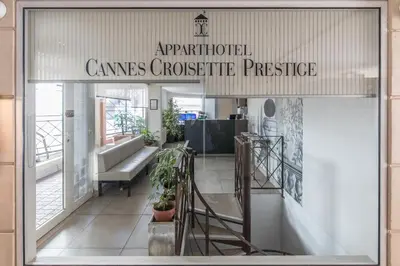 a store front with a sign that reads apparatusidated crimes corrective prestige at Cannes Croisette Prestige Apart'hotel in Cannes