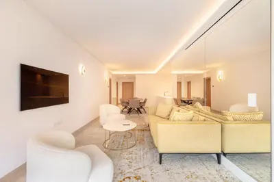 a living room with a couch and chairs and a tv at Agence AICI - Appartements Gray d'Albion in Cannes