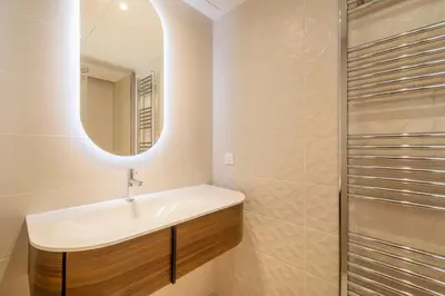 a bathroom with a sink and a mirror at Agence AICI - Appartements Gray d'Albion in Cannes