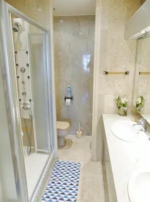 a bathroom with a shower and a sink and a toilet at Agence AICI - Appartements Gray d'Albion in Cannes