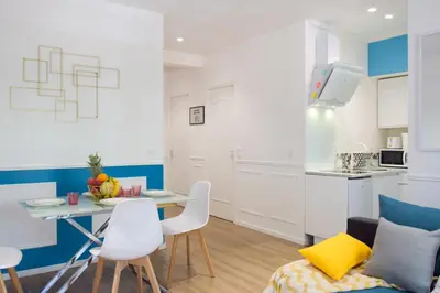 a kitchen and living room with a table and chairs at - Luxury Appart Climatisé Plage - in Cannes