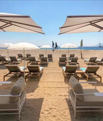 a group of chairs and umbrellas on a beach at - Luxury Appart Climatisé Plage - in Cannes