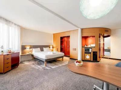 a hotel room with a bed and a table at Novotel Suites Cannes Centre in Cannes
