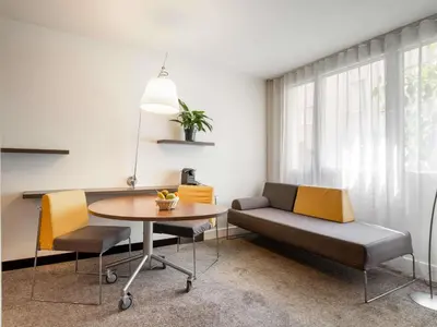 a dining room with a table and chairs at Novotel Suites Cannes Centre in Cannes