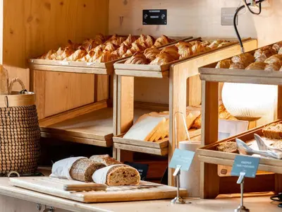 a bakery with lots of different types of bread at Novotel Suites Cannes Centre in Cannes