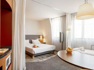 a hotel room with a bed and a table at Novotel Suites Cannes Centre in Cannes