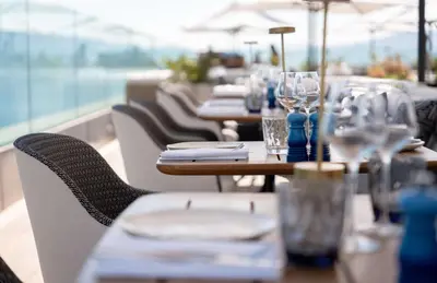 a row of tables with plates and glasses on them at Canopy by Hilton Cannes in Cannes