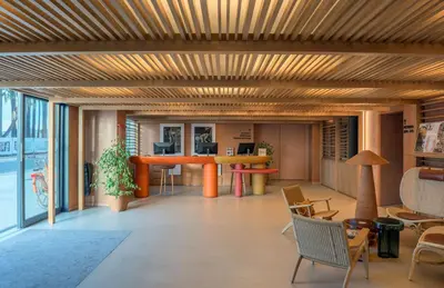 a living room with a wooden ceiling and a table at Canopy by Hilton Cannes in Cannes