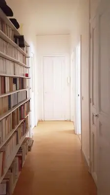 an empty hallway with shelves of books and a door at CANNES - À DEUX PAS DU PALAIS DES FESTIVALS in Cannes