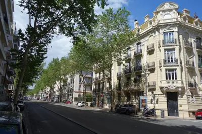 an empty street in front of a large building at CANNES - À DEUX PAS DU PALAIS DES FESTIVALS in Cannes