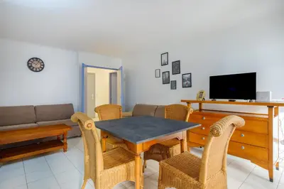 a living room with a table and a couch at Residhotel Villa Maupassant in Cannes
