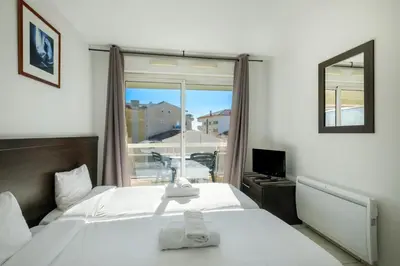 a hotel room with a bed and a window at Residhotel Cannes Festival in Cannes