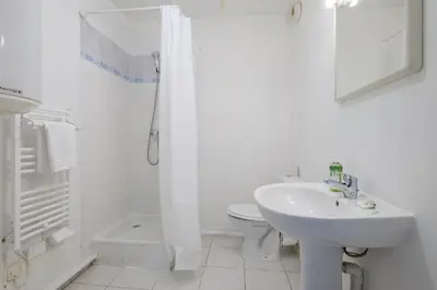 a white bathroom with a sink and a toilet at Residhotel Cannes Festival in Cannes