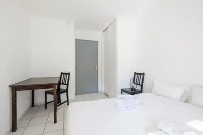 a bedroom with a desk and a bed and a table at Residhotel Cannes Festival in Cannes