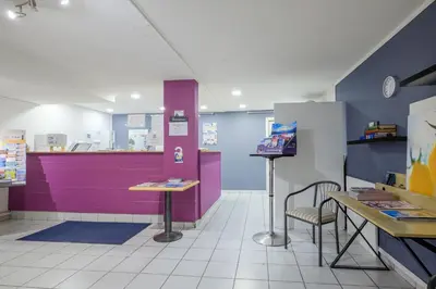 a fast food restaurant with purple and purple walls at Residhotel Cannes Festival in Cannes