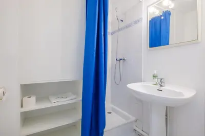 a white bathroom with a sink and a shower at Residhotel Cannes Festival in Cannes