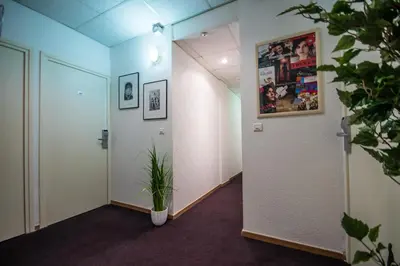 a hallway with a plant in the middle of a room at Little Palace in Cannes