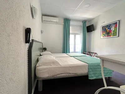 a hospital room with a bed and a desk at Little Palace in Cannes