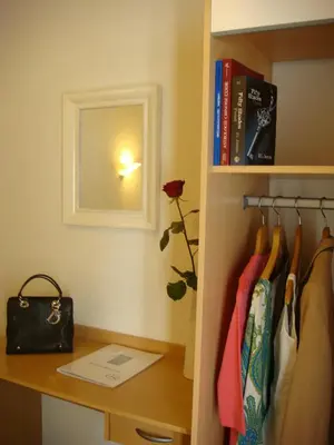 a room with a desk and a shelf with books at Little Palace in Cannes