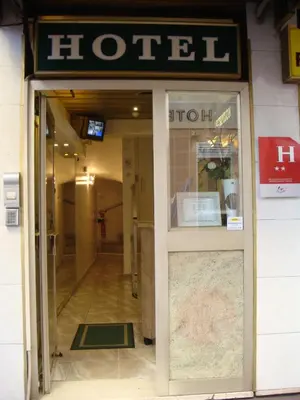 a hotel entrance with a sign above the door at Little Palace in Cannes