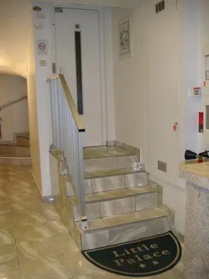 a staircase in a building with a sign on the floor at Little Palace in Cannes