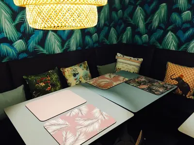 a table with pillows on top of it with a lamp at Hotel Alnea in Cannes